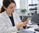 Quality engineer inspecting a power bank battery indicator at an electronics test bench
