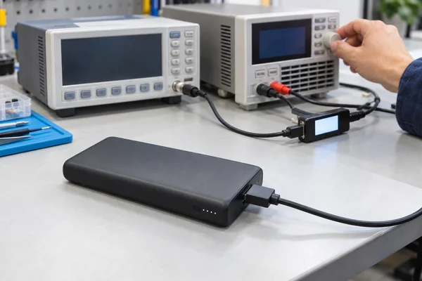 Power bank connected to electronic test equipment for display-behavior inspection