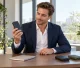 Business professional examining a solar power bank sample in a bright office