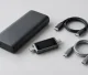 Generic power bank, compact USB-C power meter, and coiled cables on a studio tabletop